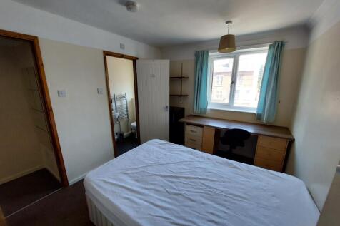 Spacious double bedroom featuring ample natural...
