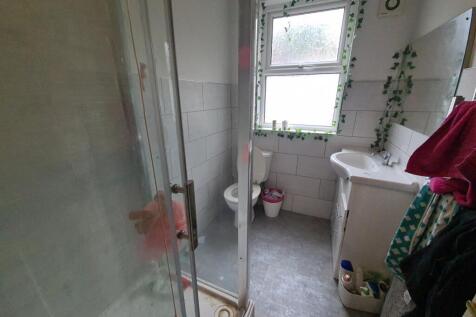 A clean and functional bathroom featuring a sho...