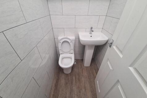Bright and clean small toilet room featuring mo...