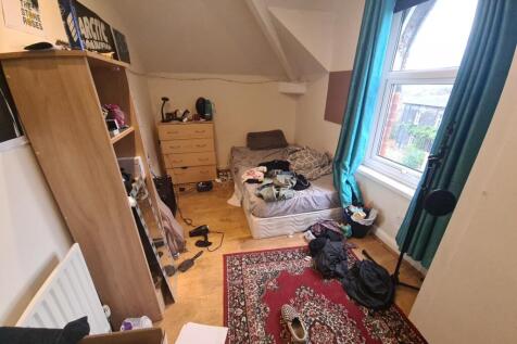 Cozy single bedroom featuring a comfortable bed...