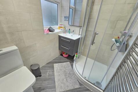 Bright and modern bathroom featuring a curved g...