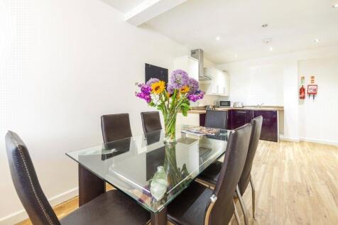 Bright and modern kitchen featuring a sleek gla...