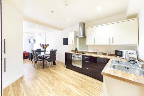 A modern kitchen with sleek cabinetry, a spacio...