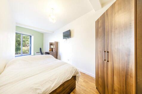 Bright and welcoming double bedroom featuring a...