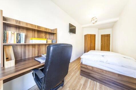 Bright and tidy single bedroom featuring a wood...