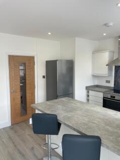 Modern kitchen featuring a sleek grey counterto...