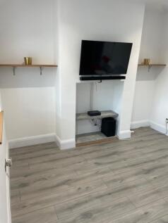 A modern living room featuring light wood floor...