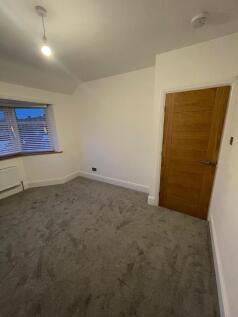 A clean and well-maintained room featuring a so...