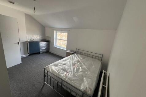 A tidy double bedroom featuring a metal framed ...