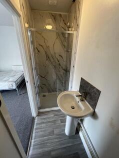 A modern bathroom featuring a sleek shower encl...