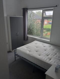 A neat double bedroom featuring a comfortable m...