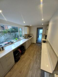 Bright and modern kitchen featuring sleek white...
