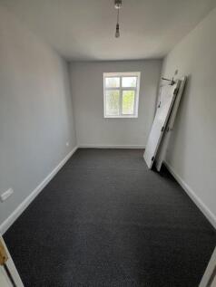 A clean and freshly painted single bedroom with...