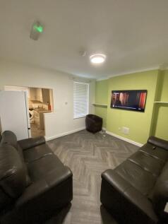 A contemporary living room featuring two comfor...