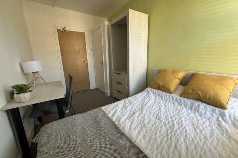 A clean and tidy single toilet room with a wood...