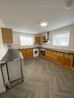 Bright and spacious kitchen featuring ample cou...