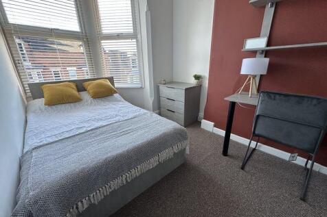 Bright and cozy double bedroom featuring a comf...