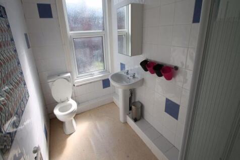 Bright and clean bathroom featuring a large win...