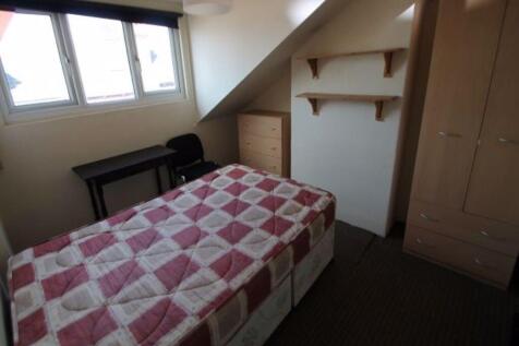 Cozy single bedroom featuring a comfortable bed...