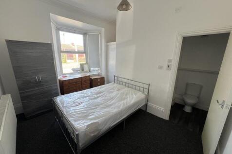 Bright and well-lit master bedroom featuring a ...