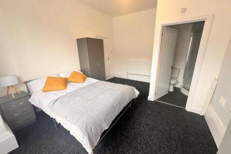 Bright and spacious master bedroom featuring a ...