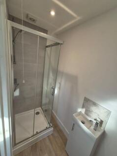 A modern and clean bathroom featuring a glass-e...