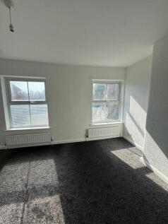 Bright double bedroom featuring two large windo...