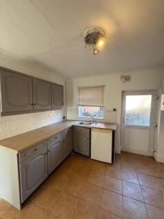 Compact kitchen area with ample countertop spac...