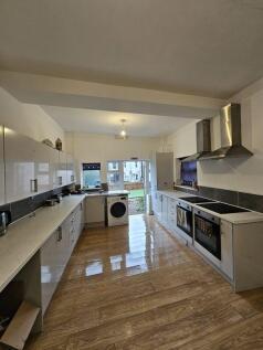 Bright and spacious kitchen featuring sleek whi...