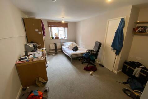 Cozy single bedroom featuring a comfortable bed...
