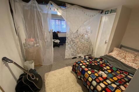 Cozy single bedroom featuring a comfortable bed...