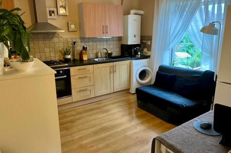 A bright and tidy kitchen featuring modern wood...