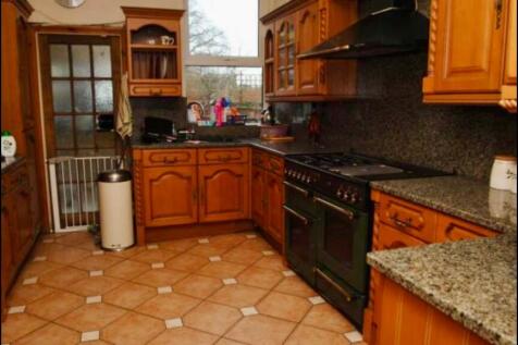 A warm and inviting kitchen featuring classic w...