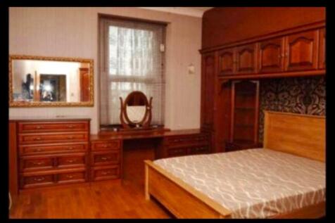 A cozy double bedroom featuring classic wooden ...