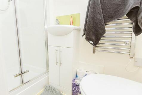 A bright and tidy bathroom suite featuring a mo...