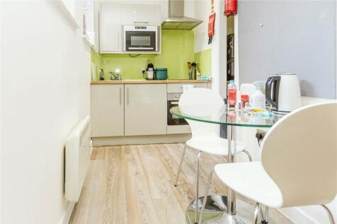 Bright and modern kitchen featuring light woode...