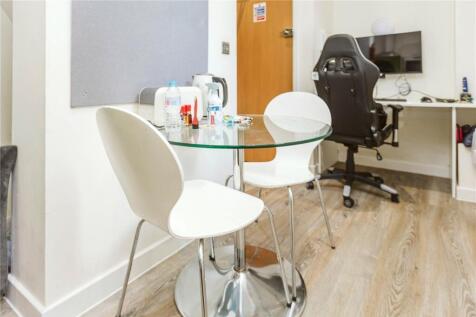 A bright and tidy communal workspace featuring ...