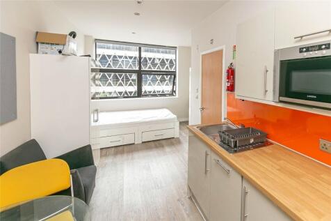 Bright and modern kitchen with sleek wooden cou...