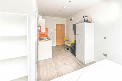 A bright and tidy single bedroom featuring ligh...
