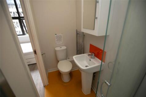 A neat and modern bathroom featuring a white to...