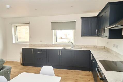 Bright and modern kitchen featuring sleek dark ...