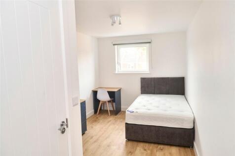 A clean and bright double bedroom featuring a c...
