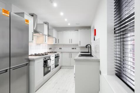 Modern kitchen featuring sleek cabinetry, ample...