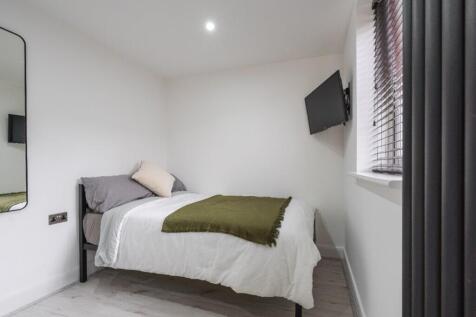 Cozy double bedroom featuring a comfortable bed...