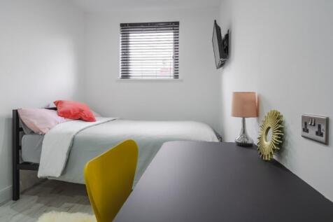 This inviting double bedroom features a cozy be...