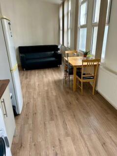 Bright and tidy kitchen area featuring wood-eff...