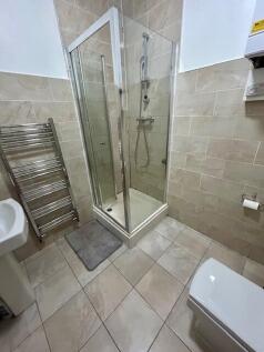 Well-maintained bathroom featuring a modern gla...