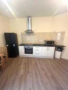 Bright and tidy kitchen area featuring modern a...