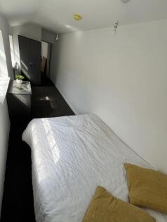 A bright, clean double bedroom featuring a neat...