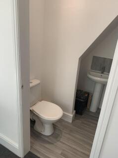 A clean and well-maintained single toilet with ...
